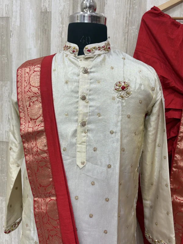 Pure tissue kurta having beautiful maggam work on collar, hands & chest part paired with red dhoti and kanduva
