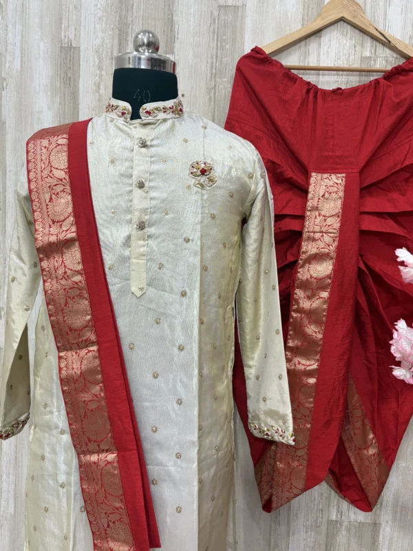 Pure tissue kurta having beautiful maggam work on collar, hands & chest part paired with red dhoti and kanduva