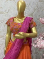 Orange colour floral lehenga with maggam work highlights on blouse with pretty dupatta