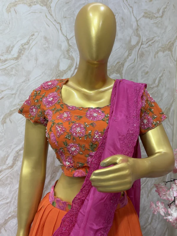 Orange colour floral lehenga with maggam work highlights on blouse with pretty dupatta