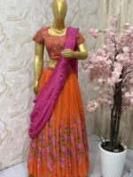 Orange colour floral lehenga with maggam work highlights on blouse with pretty dupatta