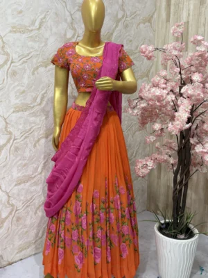 Orange colour floral lehenga with maggam work highlights on blouse with pretty dupatta