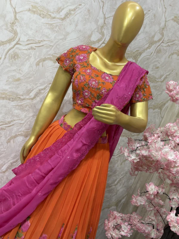 Orange colour floral lehenga with maggam work highlights on blouse with pretty dupatta