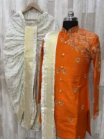 Pure raw silk Orange sherwani having maggam work on shoulder part paired with dhoti & kanduva