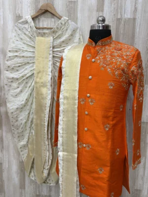Pure raw silk Orange sherwani having maggam work on shoulder part paired with dhoti & kanduva