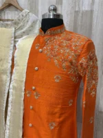 Pure raw silk Orange sherwani having maggam work on shoulder part paired with dhoti & kanduva