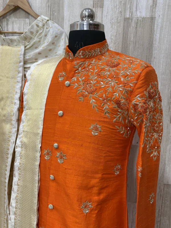 Pure raw silk Orange sherwani having maggam work on shoulder part paired with dhoti & kanduva