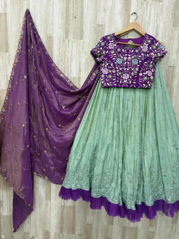 Trending tissue hand work lehenga paired with heavy maggam work blouse & dupatta