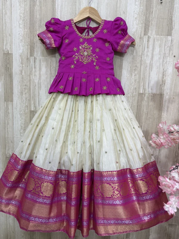 Tissue lehenga with pattu border paired with beautiful maggam work blouse
