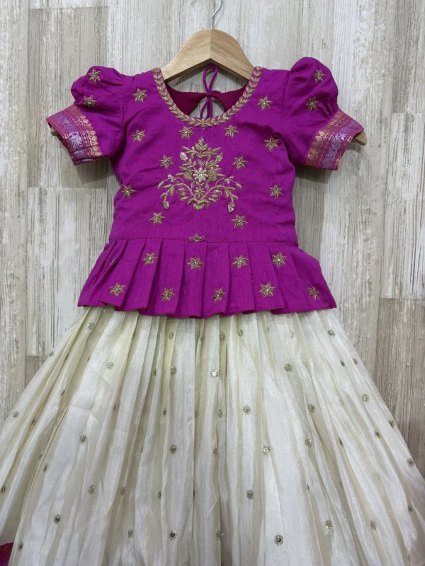 Tissue lehenga with pattu border paired with beautiful maggam work blouse