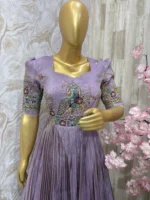 Designer tissue long gown with heavy flare & fine pleating and beautiful meenakari work on yoke part