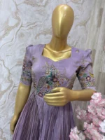 Designer tissue long gown with heavy flare & fine pleating and beautiful meenakari work on yoke part