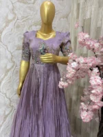 Designer tissue long gown with heavy flare & fine pleating and beautiful meenakari work on yoke part