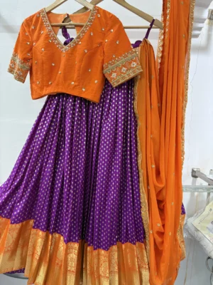 Designer lehenga with pattu border paired with beautiful maggam work blouse & contrast dupatta
