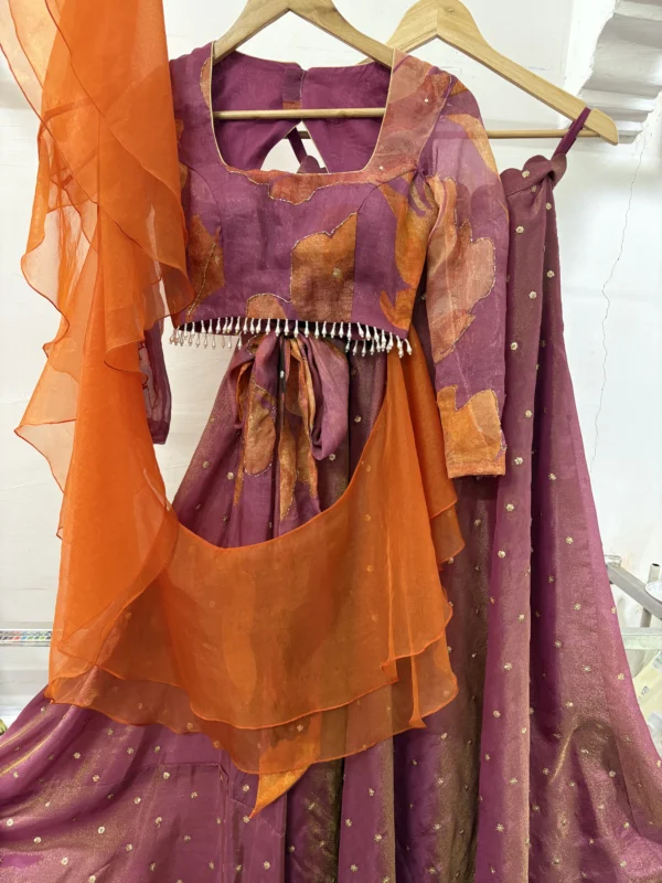 Tissue lehenga paired up with floral blouse & pretty ruffle dupatta