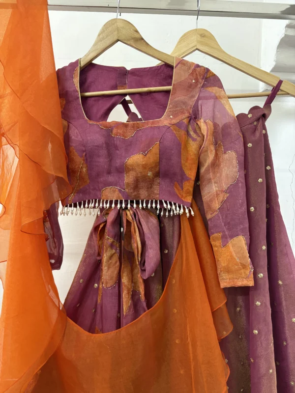 Tissue lehenga paired up with floral blouse & pretty ruffle dupatta