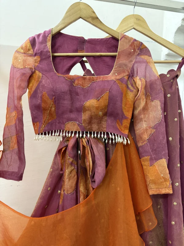 Tissue lehenga paired up with floral blouse & pretty ruffle dupatta