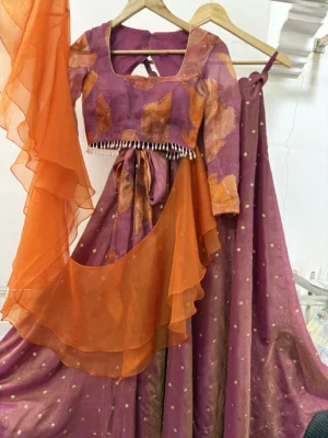 Tissue lehenga paired up with floral blouse & pretty ruffle dupatta