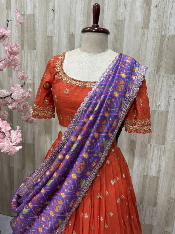 Trending orange lehenga paired with beautiful maggam work & patola silk dupatta