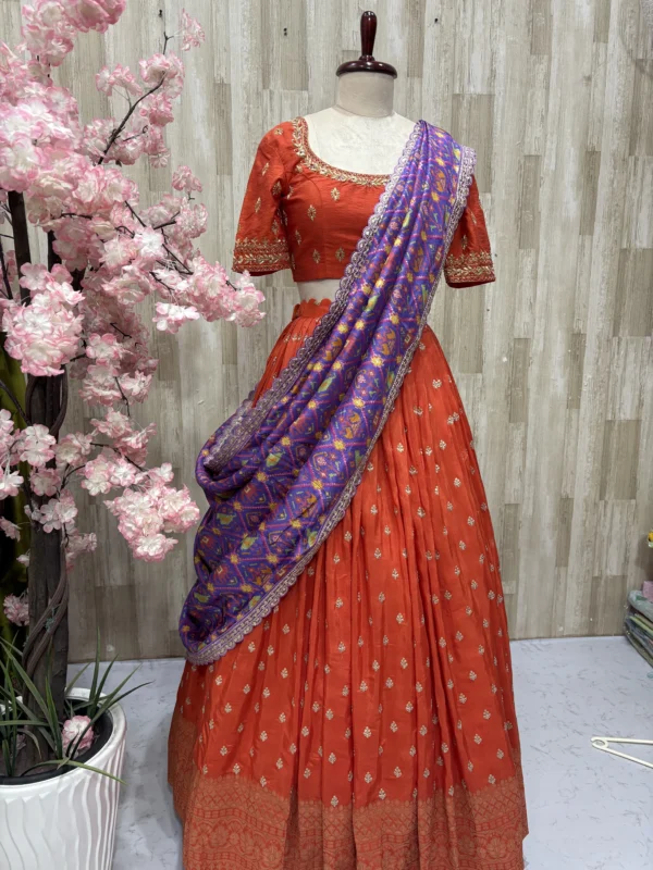 Trending orange lehenga paired with beautiful maggam work & patola silk dupatta