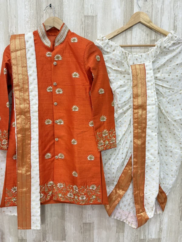 Pure raw silk Orange sherwani with heavy maggam work paired with kanduva & dhoti