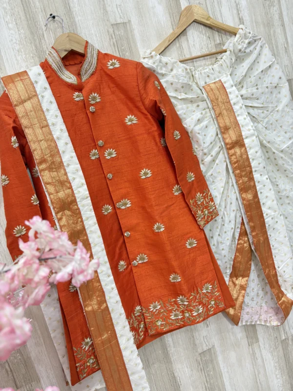 Pure raw silk Orange sherwani with heavy maggam work paired with kanduva & dhoti