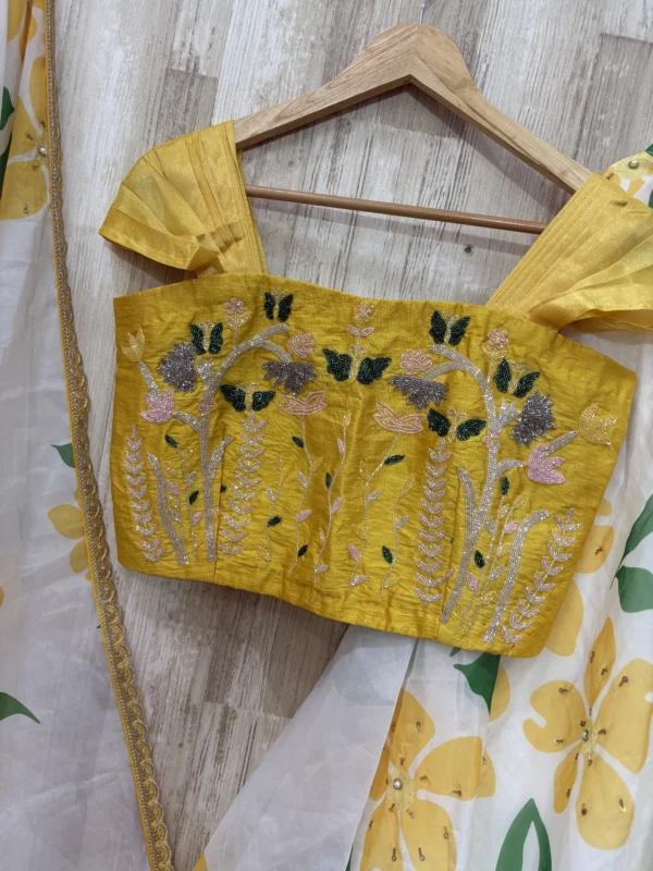 Floral organza lehenga paired with maggam work blouse & dupatta