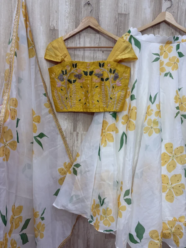 Floral organza lehenga paired with maggam work blouse & dupatta