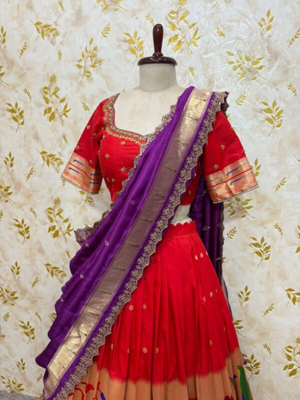 Red colour paithani lehenga paired with maggam work blouse paired with muniya dupatta
