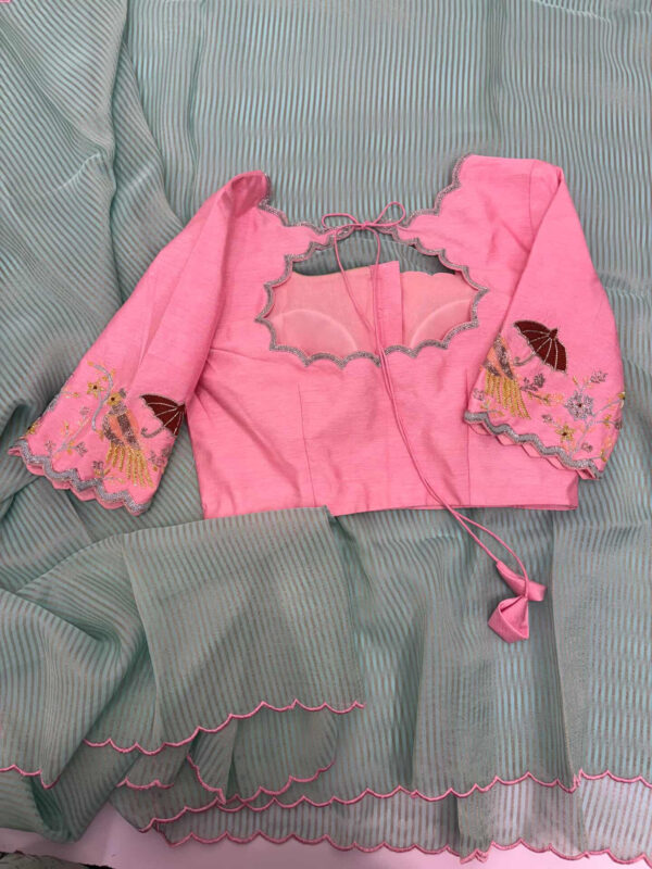 Exclusive designer kanchi organza stripes saree paired with beautiful maggam work blouse