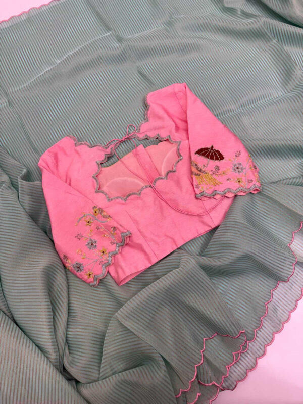 Exclusive designer kanchi organza stripes saree paired with beautiful maggam work blouse