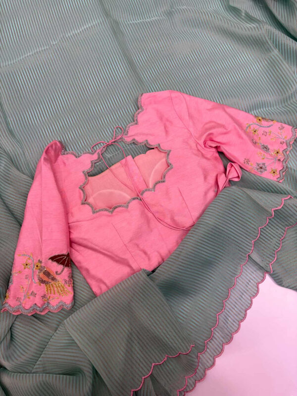 Exclusive designer kanchi organza stripes saree paired with beautiful maggam work blouse